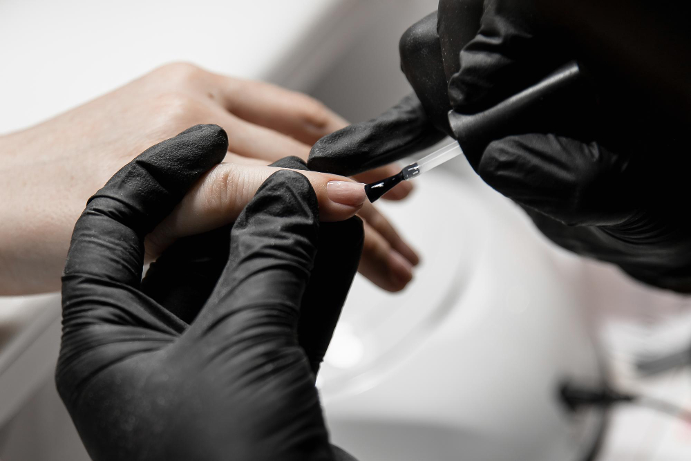 woman-apply-varnish-nails-manicurist-black-rubber-gloves